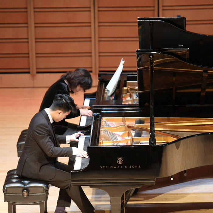 Performance studies students compete on stage.