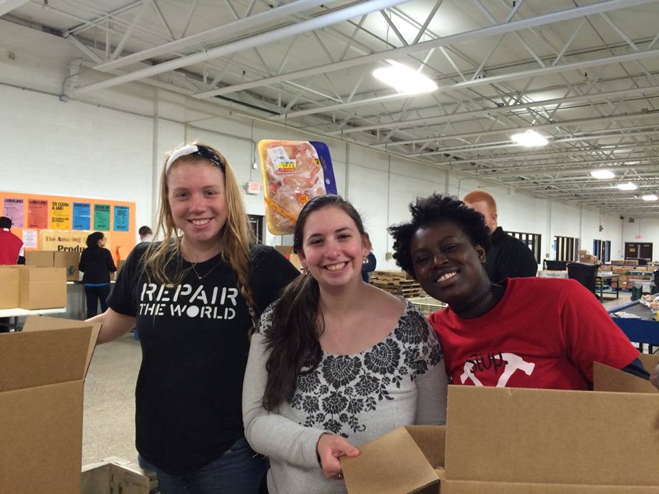 Students volunteer in food bank during a service trip to Detroit and Flint, Mich.