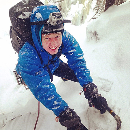 sam kilburn climbs up an icy mountain.
