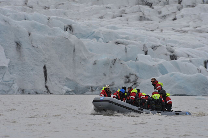 Alumni travel on a glacier lake.