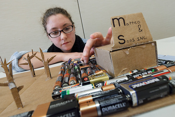 Keriann Pfleger ’17 studied a contaminated landfill near her high school. To represent the toxins in the ground, she created a zero-waste display, using all recycled products. Photo by Carl Socolow '77.
