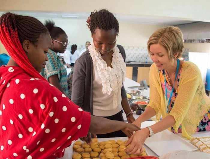 Jill Graby Shuck '93 leads a baking demonstration during the official launch of a baking program in Kenya. Led by a faith-based nonprofit, the program help adult students gain confidence and agency through community and by learning a marketable skill.