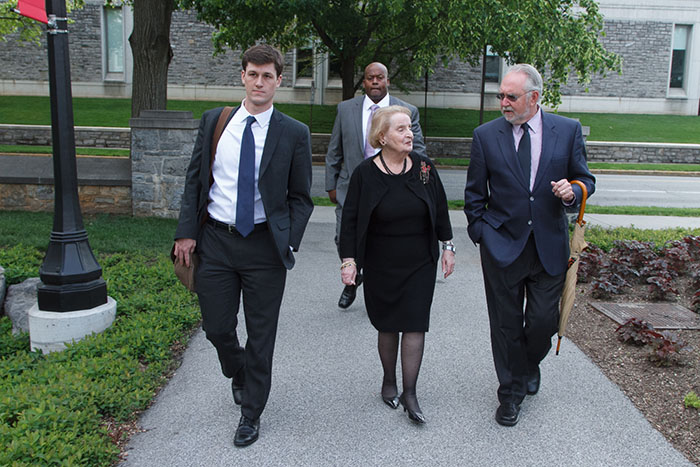 Chris Roberts (left) walks with Secretary Albright, Professor Stuart and Officer Mann