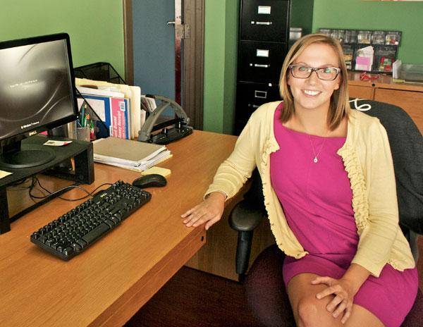 Photo of Laura Bartell sitting at her desk