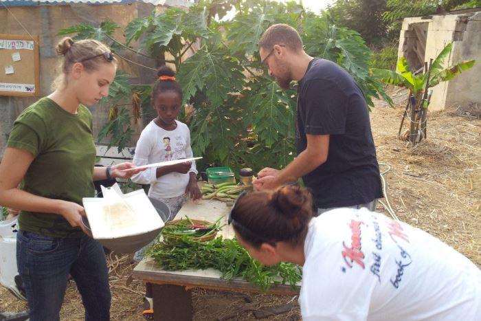Members of Yahel work in a community garden