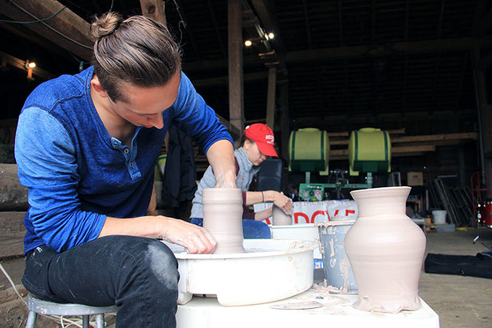 Student working on ceramics in the barn. 