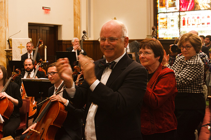 Professor Emeritus Truman Bullard delivers a standing ovation at the close of the April 27 concert. Photo by Carl Socolow '77.