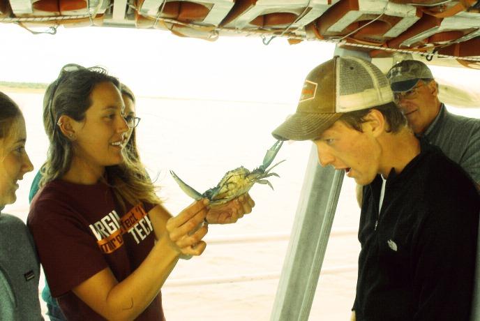 Picture of student holding crab on Chesapeake Bay