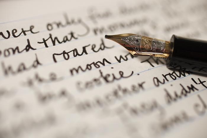 A pen rests on a manuscript
