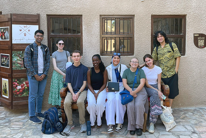Heather Johnson '25 (second from left) and Georgia Mugisha ’26  (fourth from left) and their COP28 cohort. The group witnessed top minds and global leaders grapple with some of the most pressing issues of our time.