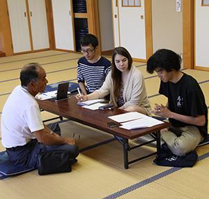 Students interviewing an older gentleman in Japan