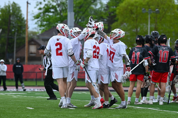 players celebrate on the lacrosse field