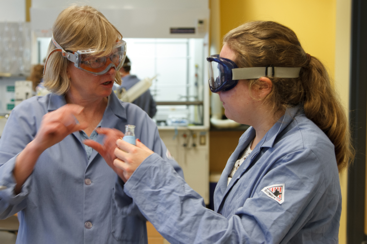 Student and faculty member in the chemistry lab.