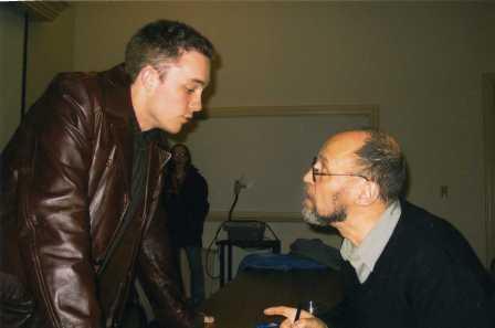 Lucas Stratton, class of 2004, speaks with Dmitri Prigov during autograph signing.