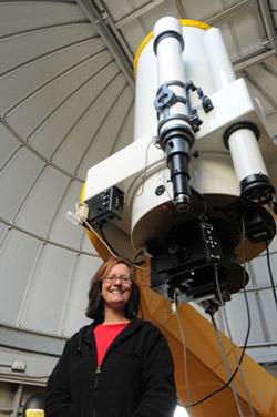 Photograph of Professor Hamilton-Drager in the Observatory beneath the telescope