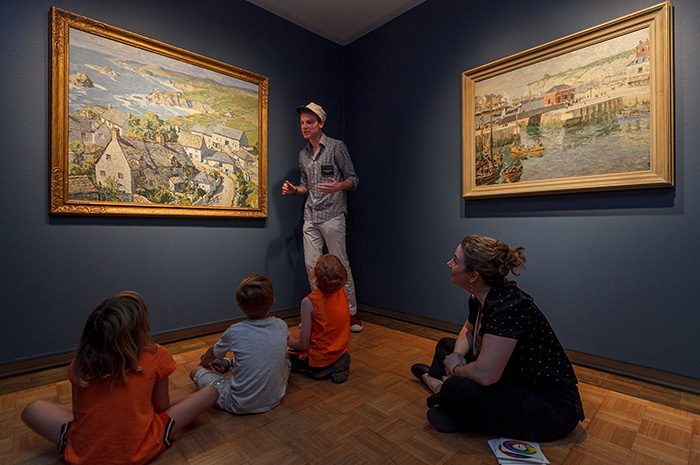 Taylor Hunkins '17 introduces local children to basic art-appreciation concepts during a June 30 community presentation in The Trout Gallery, while Curator of Education Heather Flaherty looks on. Photo by Carl Socolow '77.
