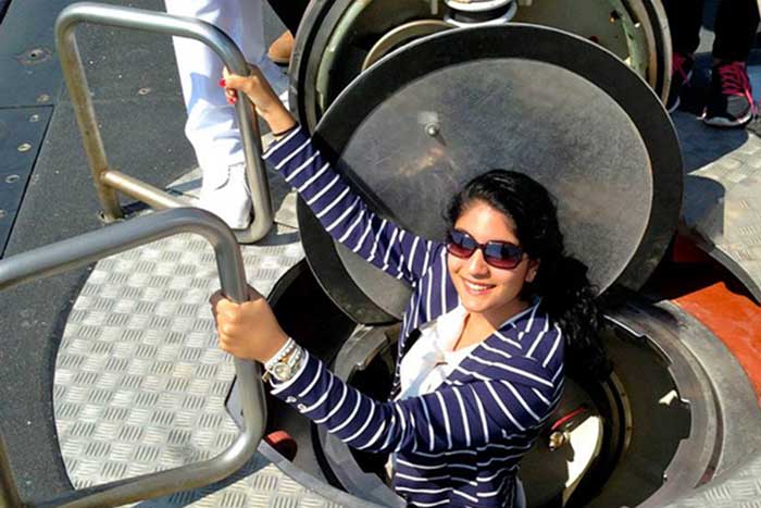 Angeline Apostolou ’15 climbs into a military submarine at a Greek naval base as part of a summer study-abroad excursion.