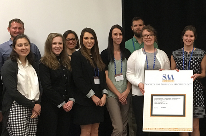 Makensie Jones '18 and Isabel Figueroa '19 (first row, first and second from left, respectively) pose after their presentation with fellow presenters and their professor, Maria Bruno (back row, second from left).