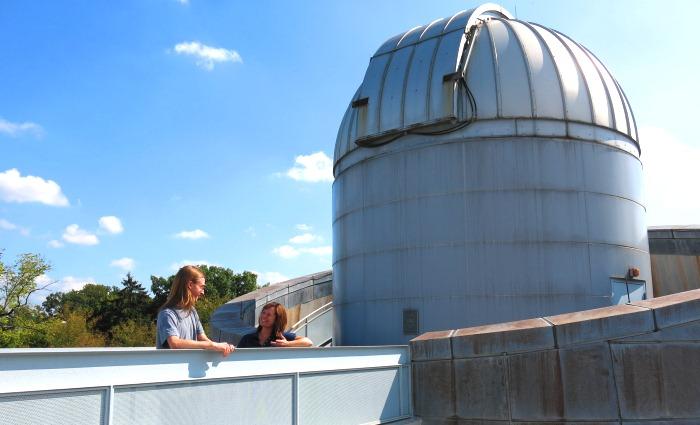 Ben Kimock and Catrina Hamilton-Drager take a break from their research outside the Britton Observatory.