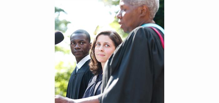 Jahmel Martin and Jessica Klimoff listen as Joyce Bylander introduces them during the Convocation ceremony.