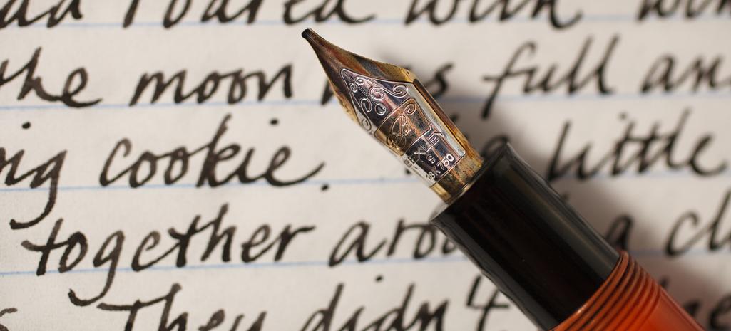 A pen resting on a manuscript. 