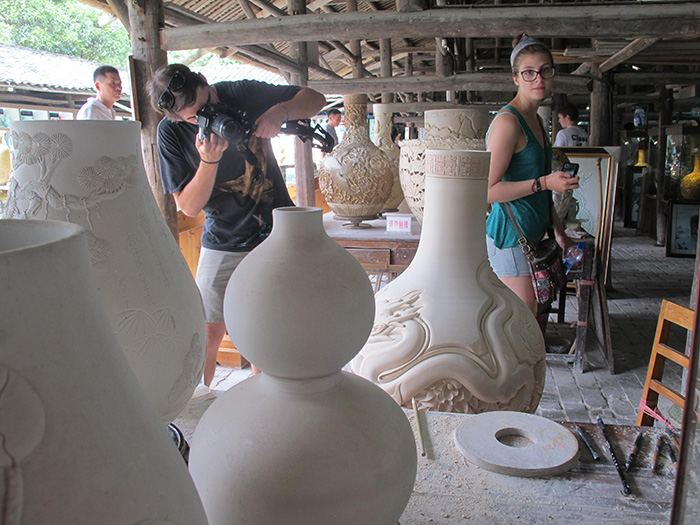 Joelle Cicak takes in the emerging porcelain vases.