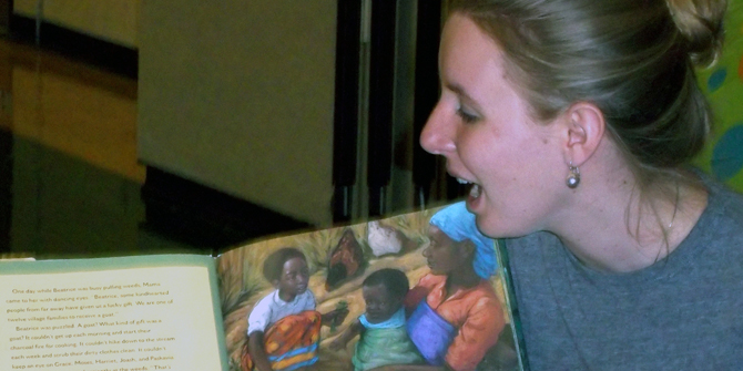 Dickinson College educational studies student reading a children's book.