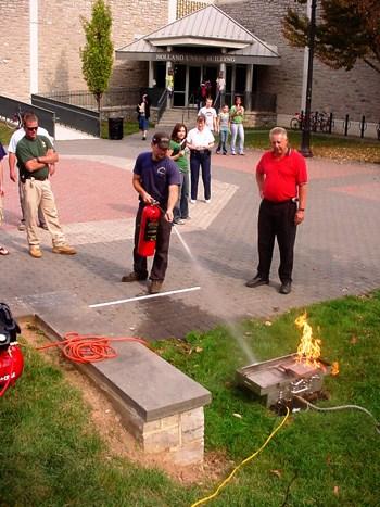 Testing a fire extinguisher during safety training.
