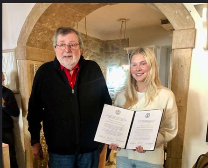 Sloan Maas '21 (right) poses with former Bologna Center professor--and music icon--Francesco Guccini. Maas is the first recipient of a study-abroad scholarship established in the singer-songwriter's honor.