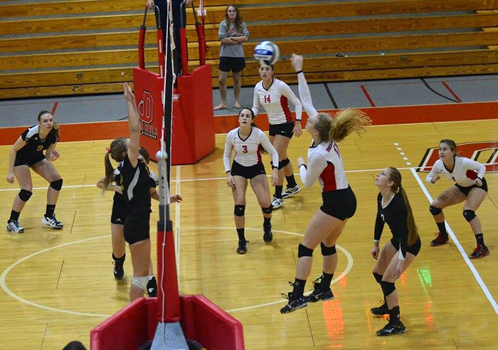 Lauren Beecher '18 (third from right) on the volleyball court.