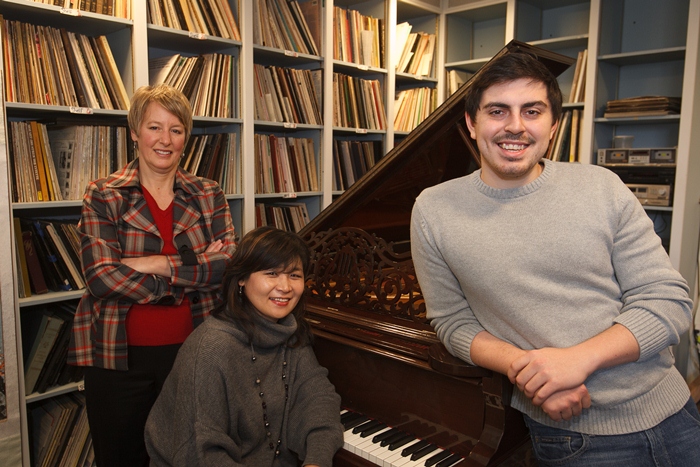 Frederick Schlick poses at the piano with his instructors.