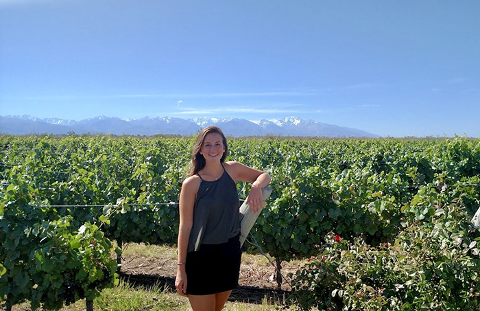 Natalie Cassidy '18 poses in a vineyard in Mendoza, Argentina, where she conducted original research.