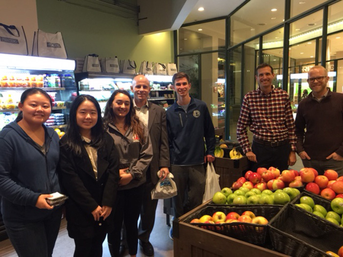 Students in a Fundamentals of Business class taught by Steve Riccio (center) visit with the owners of Provisions grocery store, in Harrisburg, Pa.