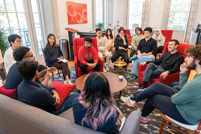 A circle of students attend a Burgess Institute event