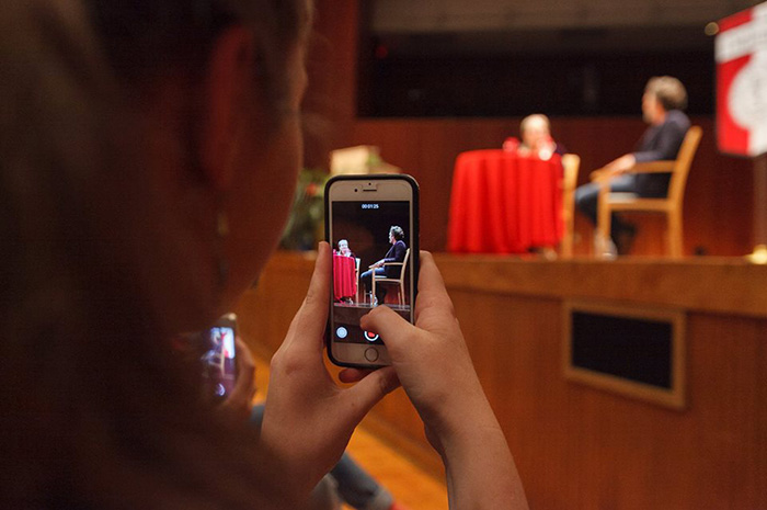 A Dickinson College student snaps a photo of Mark Ruffalo during his public address on campus.
