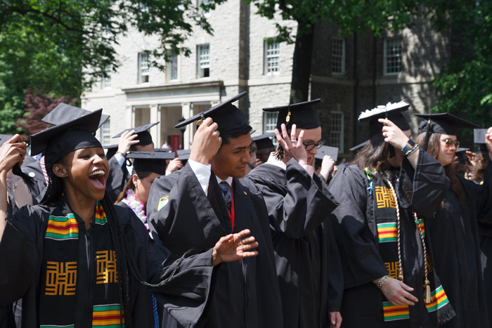 Members of the class of 2018 move their tassels from right to left, marking their transition from students to graduates. Photo by Carl Socolow '77.