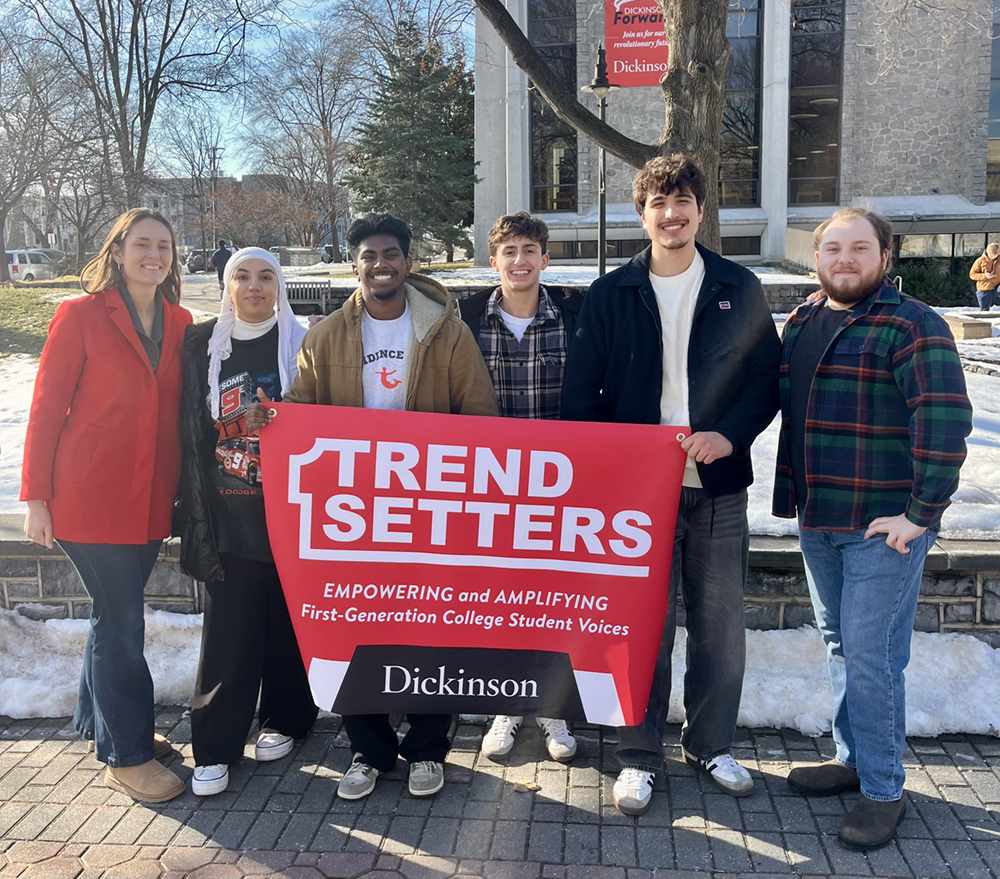Students smiling with Trendsetters Banner