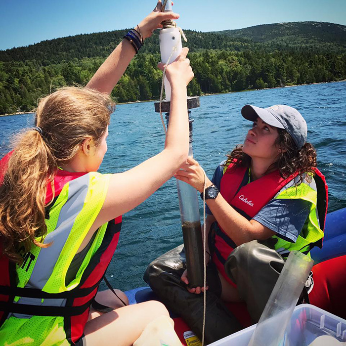 students working at a lake