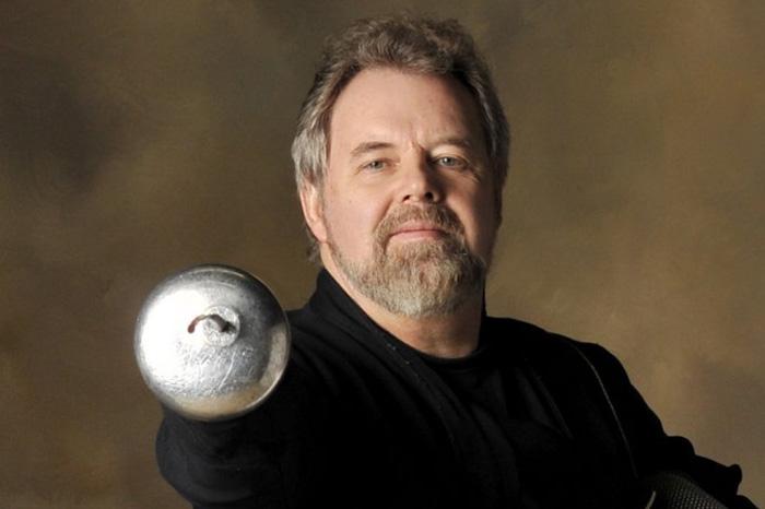 Mark Holbrow '74 poses with a tool of his trade. Photo by Bob Krist.