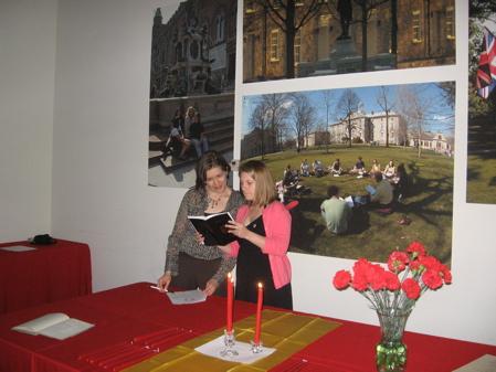 Sigma Delta Pi advisor Prof. Mariana Past (left) goes over ceremony details with Sarah Brnich.