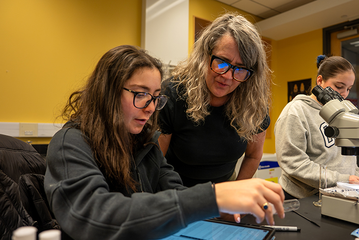 Two woman of different generations work together in a lab setting.