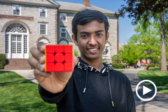 Radiath Kamal Patwary '28 holds out a Rubik's Cube.