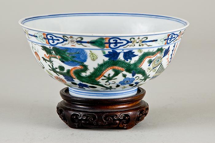 Photograph of a Chinese bowl with dragons painted on it.