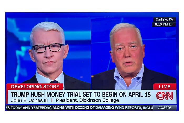 Screenshot of CNN's Anderson Cooper 360 showing two men on a television.