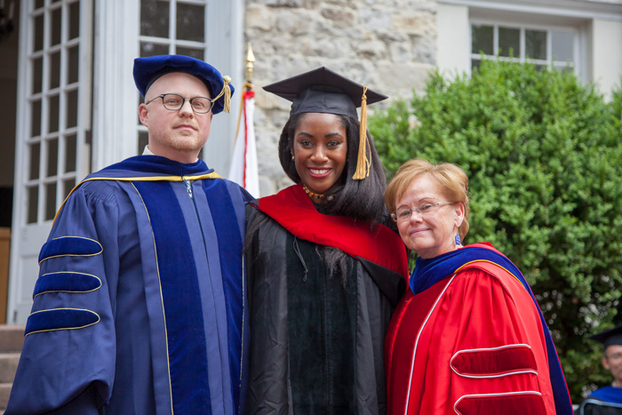 Karen Attiah, the Washington Post's global opinions editor, poses with Ensign and 
Associate Professor of Sociology Erik Love after receiving her Doctor of Journalism honorary degree.