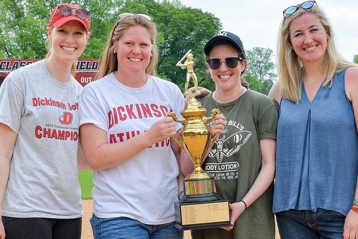 Softball players with trophy