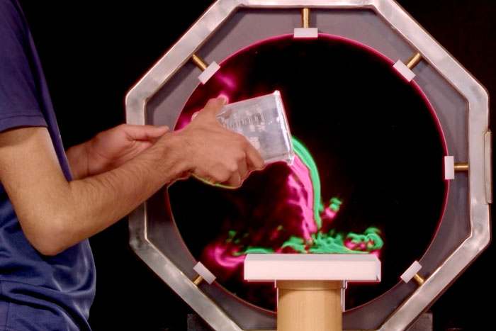 Carbon dioxide gas is poured into a beaker.