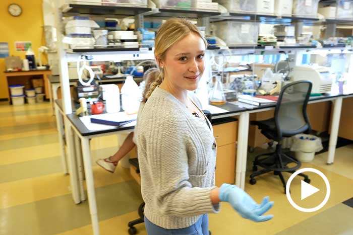 a student hosts a tour of the biology lab