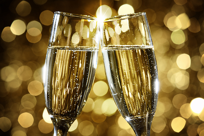 two champagne glasses clinking (toast)