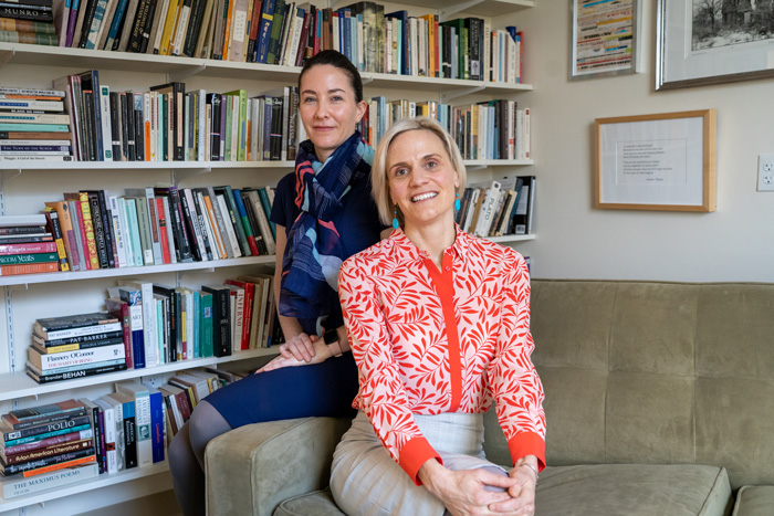 Claire seiler and alyssa deblasio pose on a couch